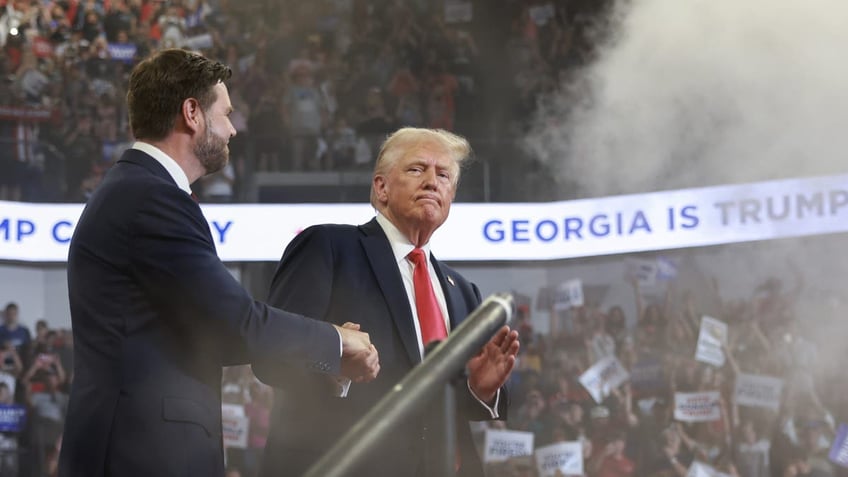 Republican presidential nominee Donald Trump takes the stage with his vice presidential running mate, Sen. J.D. Vance, during a campaign rally at the Georgia State University Convocation Center in Atlanta on Aug. 3, 2024.