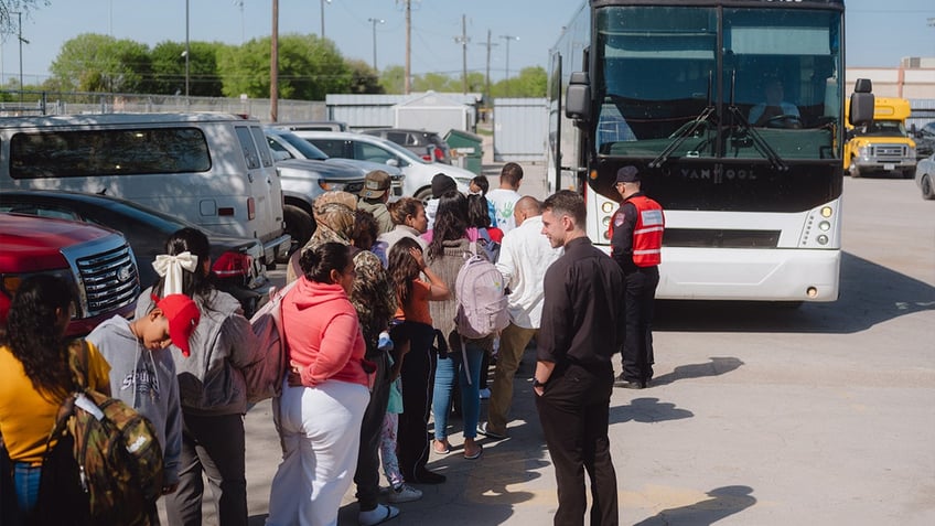 Migrants board a state-sponsored bus to New York