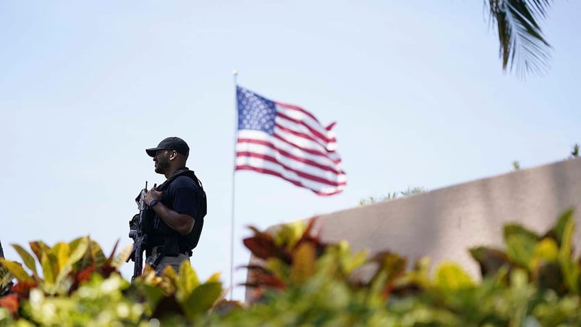 Security stands on the perimeter of former President Donald Trump's Mar-a-Lago home