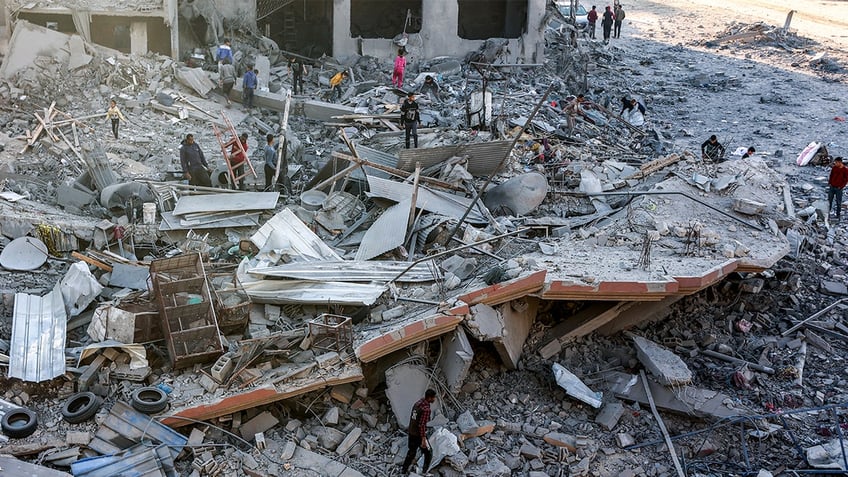 People inspect the debris and rubble at the site of Israeli bombardment on a residential block in Jalaa Street in Gaza City on Jan. 14, 2025 amid the ongoing war in the Palestinian territory between Israel and Hamas.