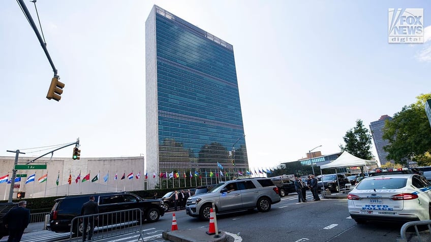 A view of the UN tower in the background with traffic in the foreground