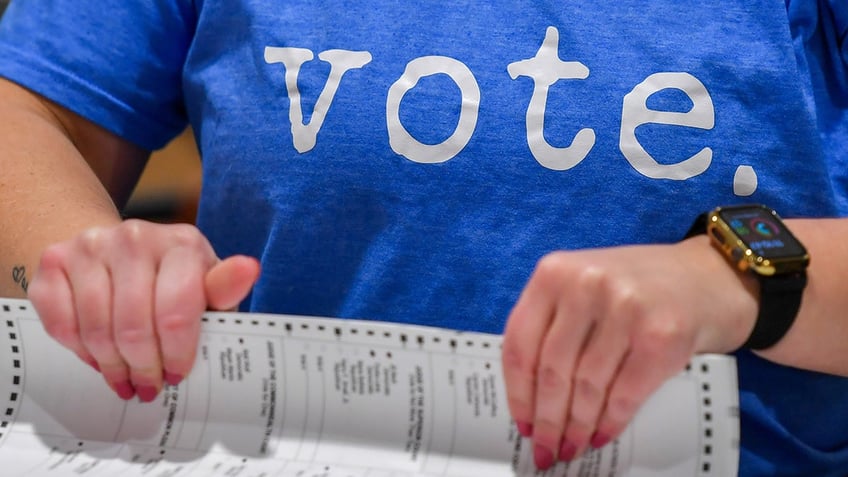 election worker handling ballots