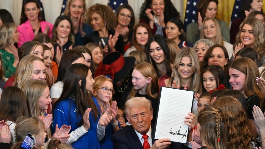 Trump signing women's sports excutive order, surrounding by girls/women athletes