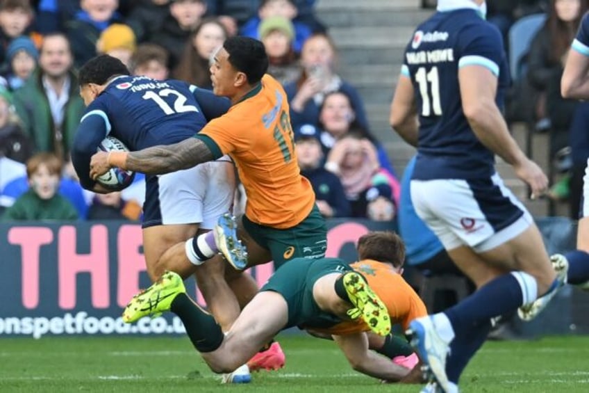 Key score: Scotland's captain Sione Tuipulotu (L) runs to the line to score the first try