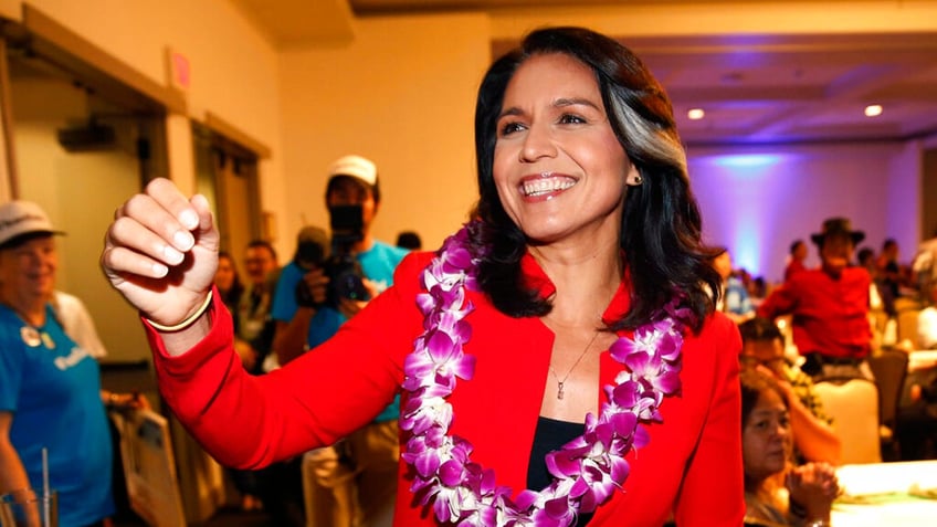 Tulsi Gabbard, a former congresswoman from Hawaii, wears a lei