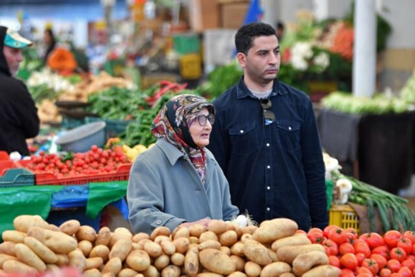 Tunisians shop for vegetables in the capital's central market