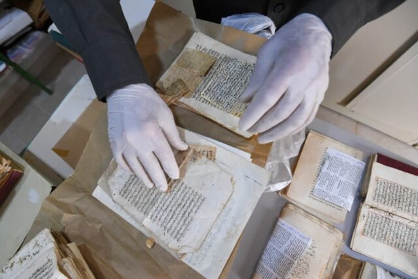 Said al-Barouni prepares to scan old manuscripts at his library