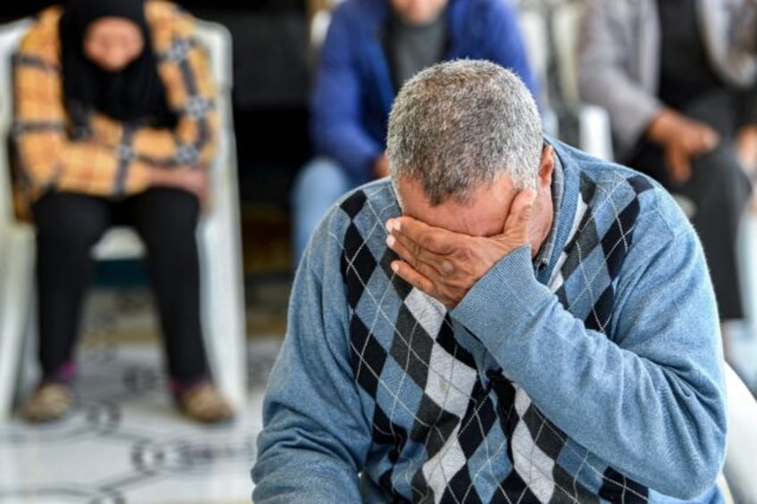 A family member of one of the Tunisian migrants who were lost at sea in January struggles