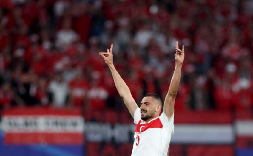 Turkey's defender Merih Demiral makes a controversial hand gesture as he celebrates scorin