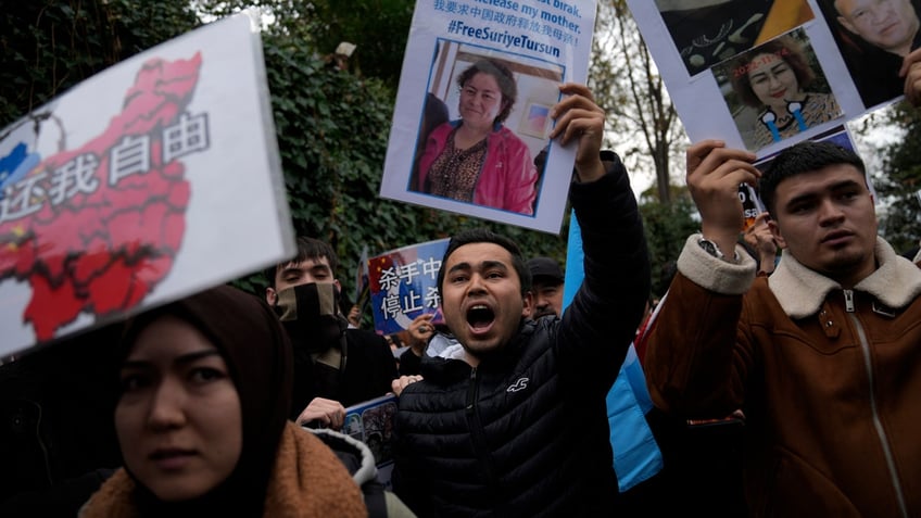 Protesters chant slogans as they hold posters and pictures of victims during a protest against China's brutal crackdown on ethnic group Uyghurs, in front of the Chinese consulate in Istanbul.