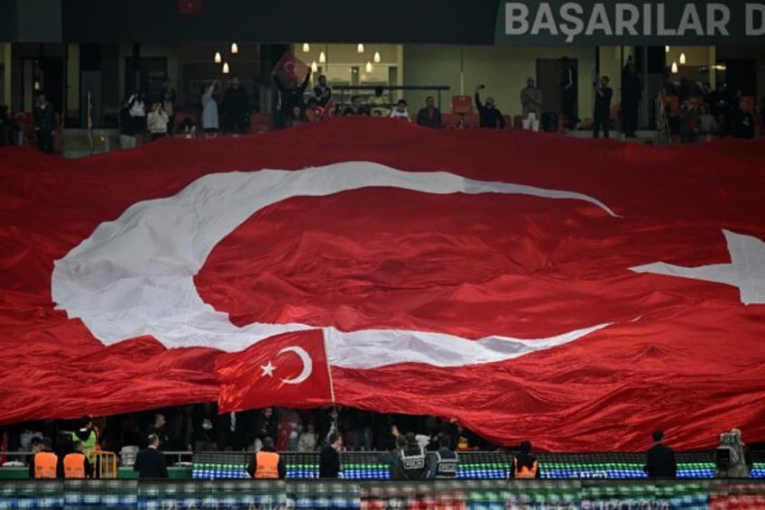 Turkey fans wave a giant Turkish national flag during a UEFA Euro 2024 qualifier in October