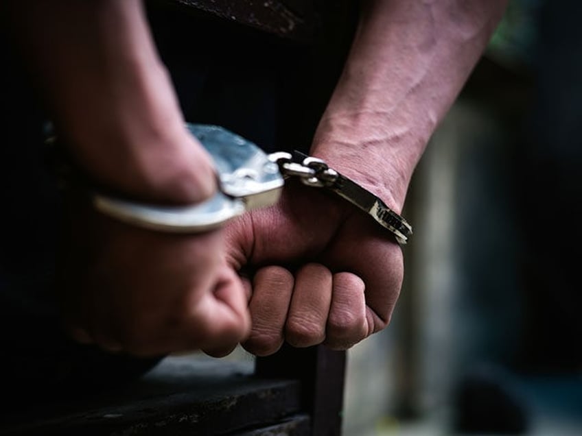 Man on the chair in Handcuffs. Rear view and Closeup ,Men criminal in handcuffs arrested f