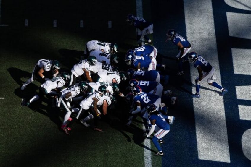 Philadelphia Eagles quarterback Jalen Hurts scores a touchdown using the team's signature