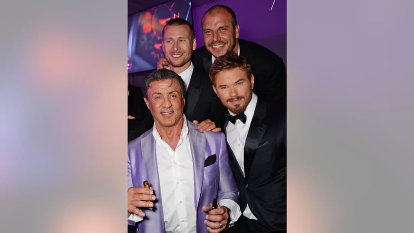 Sylvester Stallone, Glen Powell, director Patrick Hughes and Kellan Lutz posing together