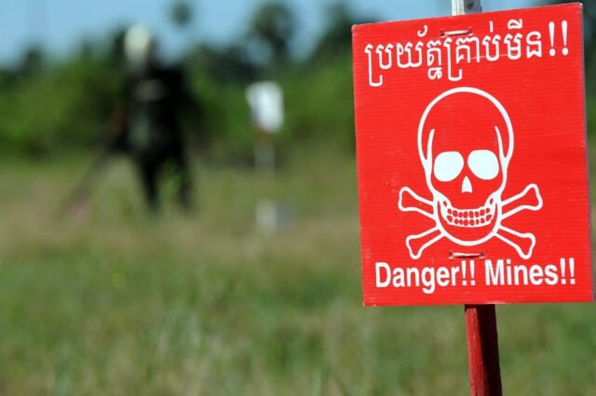 A Cambodian deminer scans for mines at a training centre in 2011, two deminers were killed