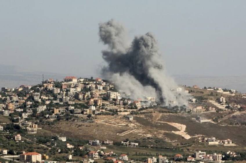 Smoke billows from the site of an Israeli strike on the southern Lebanese village of Khiam