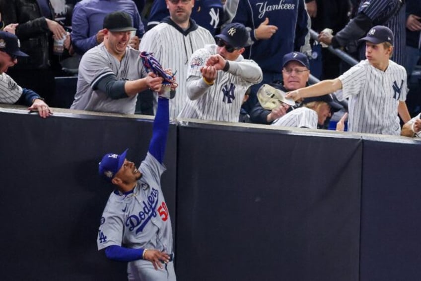 Two spectators who interfered with Mookie Betts of the Los Angeles Dodgers as he tried to