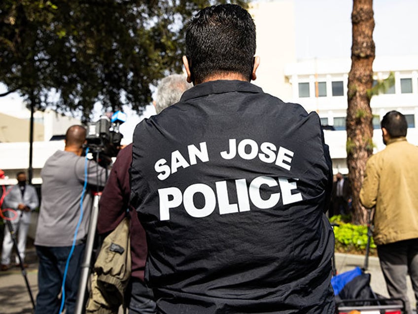 A person wears a San Jose Police jacket during a press conference outside of the San Jose