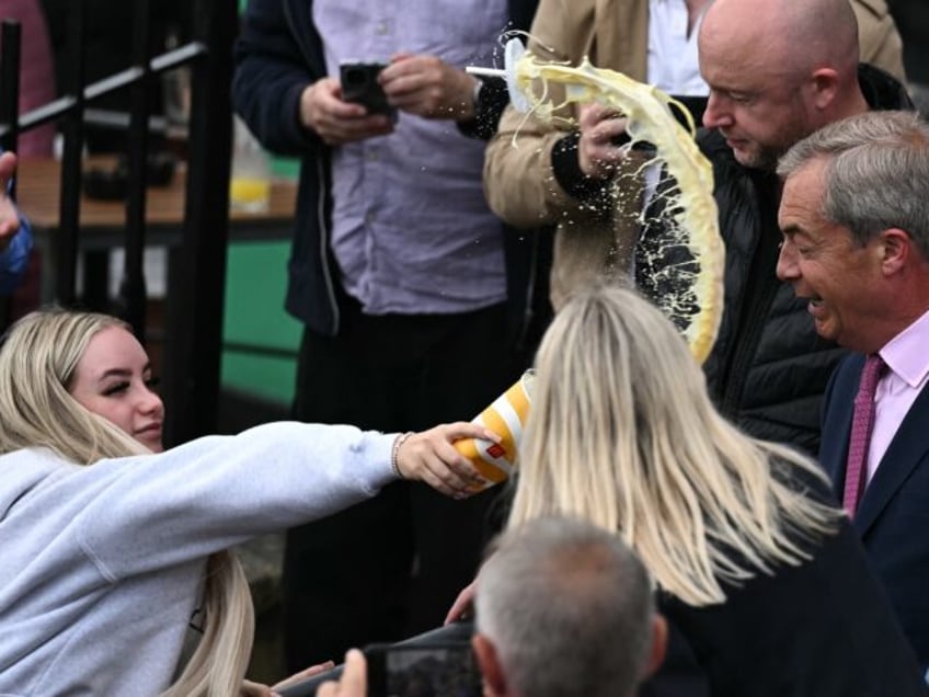 TOPSHOT - A person throws a milkshake drink in the face of newly appointed leader of Brita