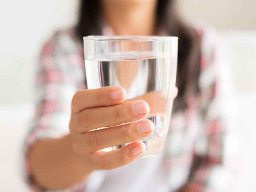 woman holding a glass of water