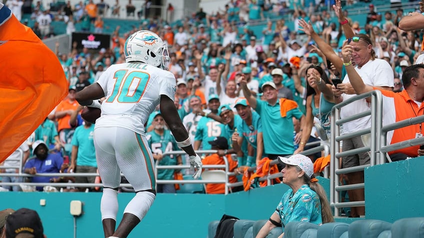 tyreek hill surprises fan with signed dolphins gear after viral touchdown ball mix up