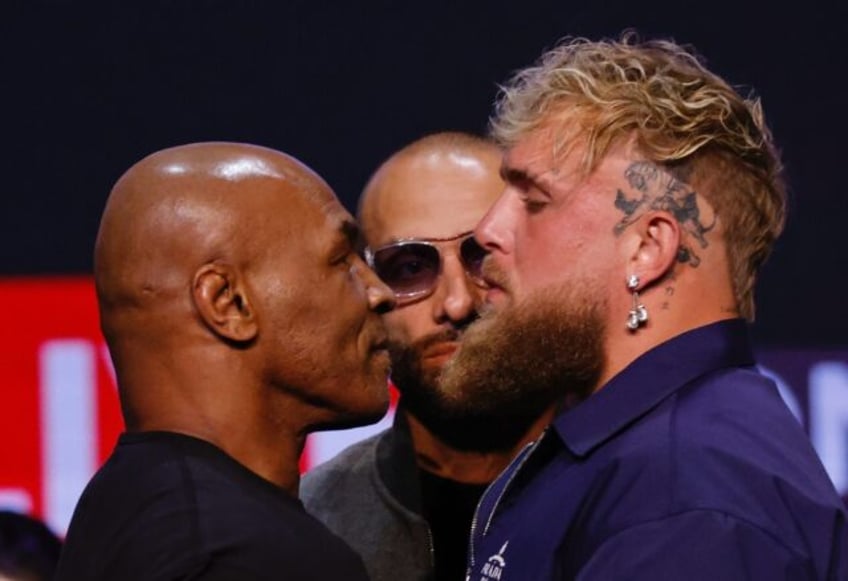 Mike Tyson (left) faces off with YouTuber Jake Paul during a New York press conference ear