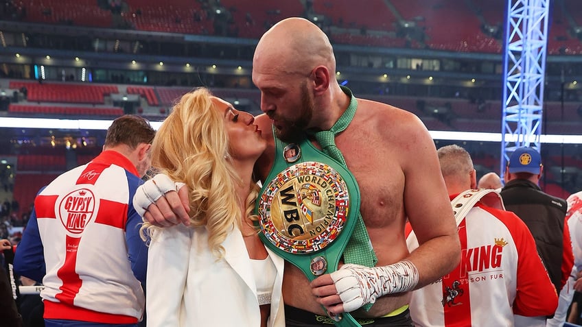 Tyson and Paris Fury kiss in boxing ring