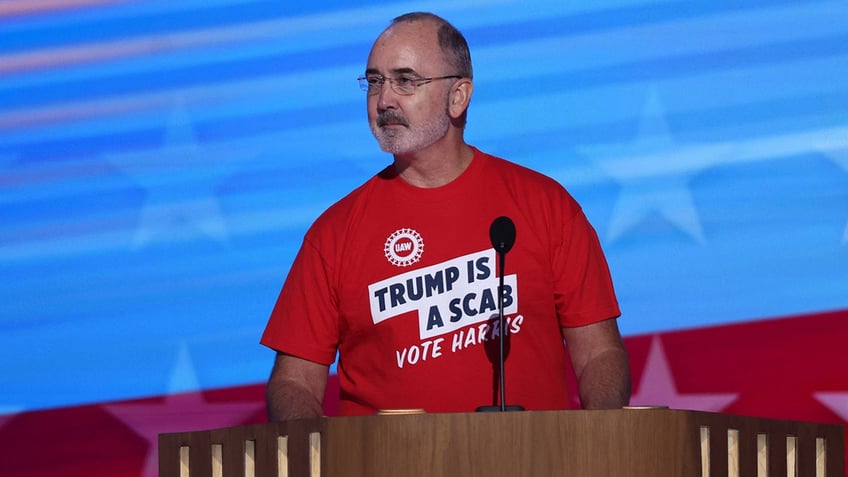 Shawn Fain speaking to the DNC in 'Trump Is a Scab' t-shirt