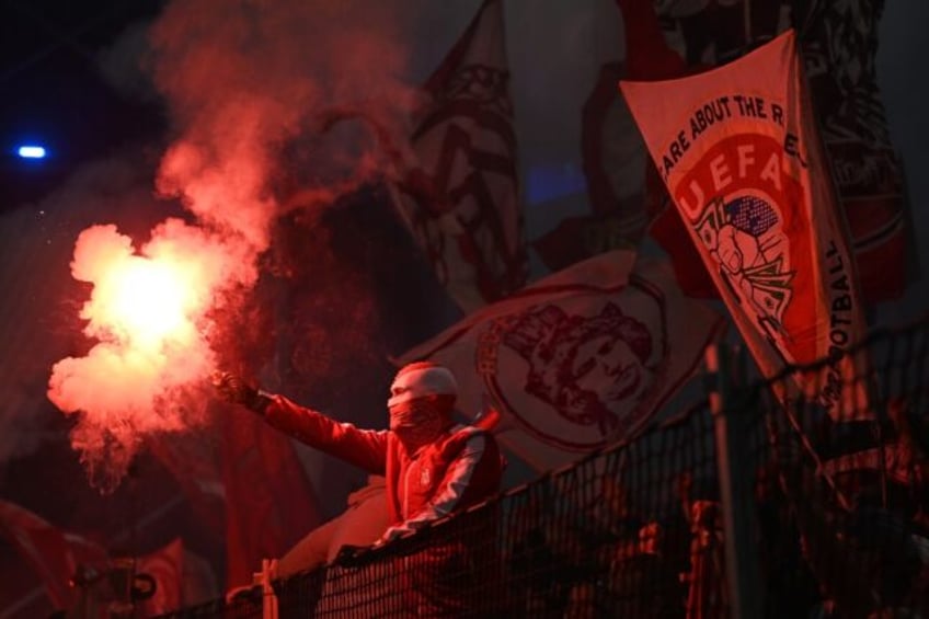 A Bayern Munich fan burns a flare during the UEFA Champions League Group A football match between FC Copenhagen and FC Bayern Munich in Copenhagen, Denmark on October 3, 2023. Bayern came from a goal down to win 2-1.