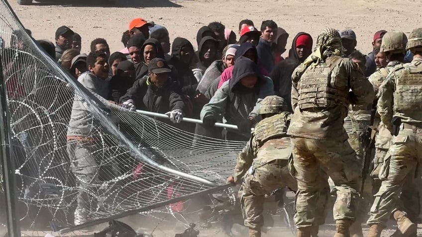 Migrants storm the gate at the border in El Paso