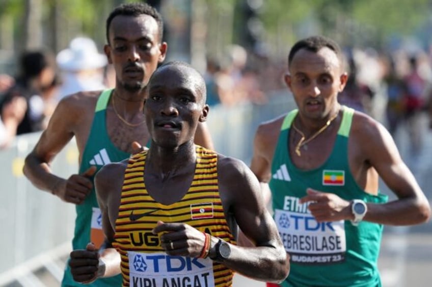 ugandas kiplangat wins mens world marathon title