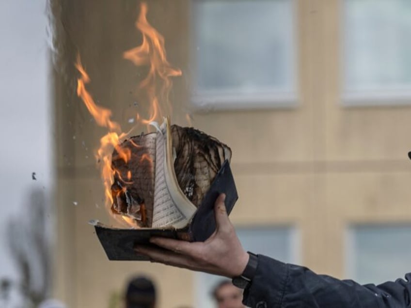 STOCKHOLM, SWEDEN - MAY 14: Rasmus Paludan burns a Koran during an election meeting in Hus