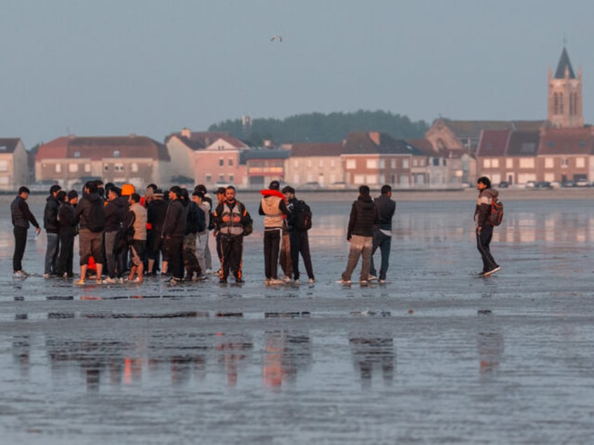 GRAVELINES, FRANCE - MAY 31: Migrants wait on the beach for a dinghy on May 31, 2025 in Gr