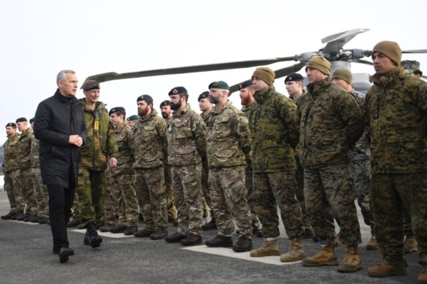 NATO Secretary General Jens Stoltenberg with British soldiers during a NATO exercise in 2022