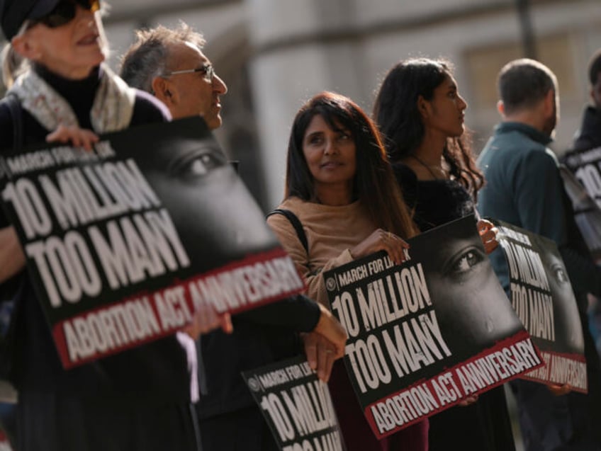 Anti-abortion demonstrators hold placards in a pro life protest in Parliament Sqaure in Lo