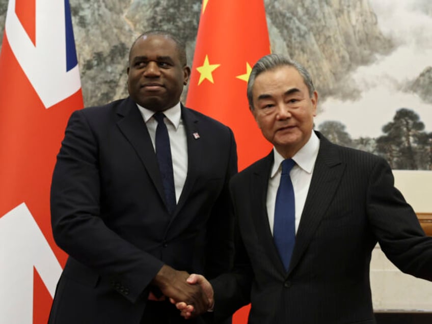 Britain's Foreign Secretary David Lammy and Chinese Foreign Minister Wang Yi shake ha