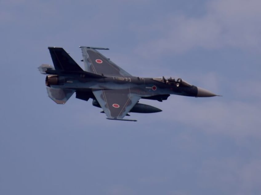 A Japan Air Self-Defense Force F2 jet fighter flies past during an annual live-fire exerci