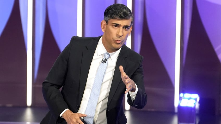 British Prime Minister Rishi Sunak appears in a suit and tie on a stage as he speaks during a BBC Question Time Leaders' Special in York, England.