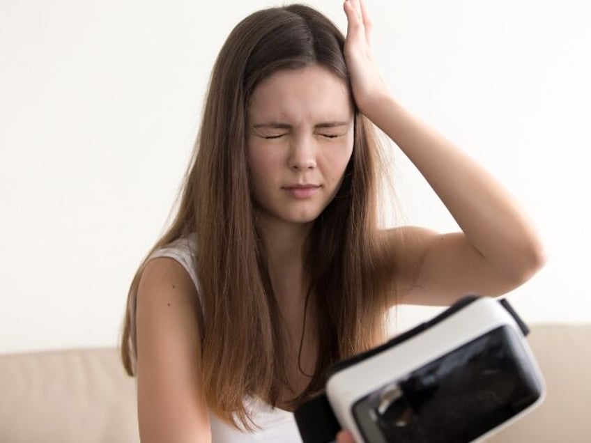 Unhappy girl with VR headset