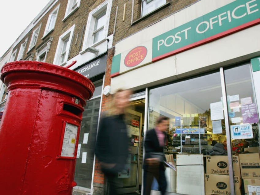 LONDON - NOVEMBER 1: People walk past a high street Post Office on November 1, 2004 in London, England. The Royal Mail has dampened down reports that it is too close or sell between 240 and 270 of its larger high street branches which are losing GBP70 million pounds a …