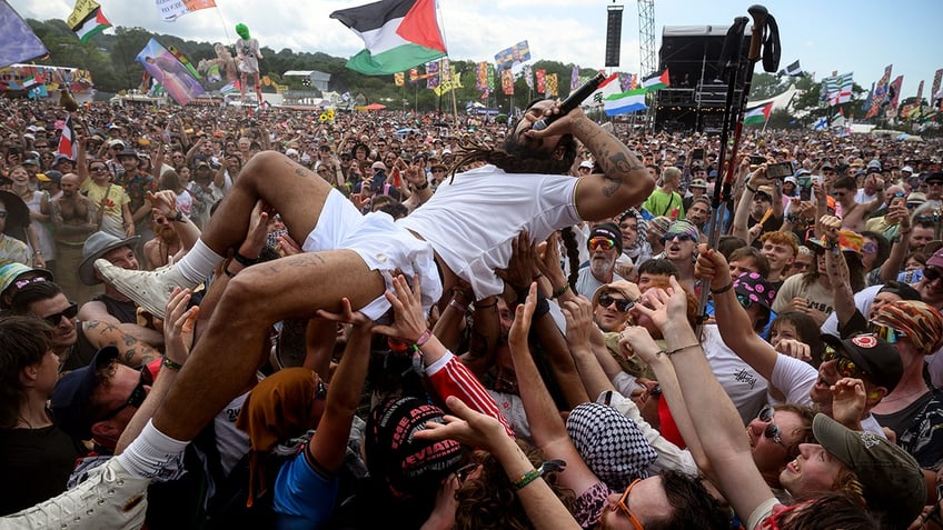 Bobby of Bob Vylan crowdsurfs at Glastonbury