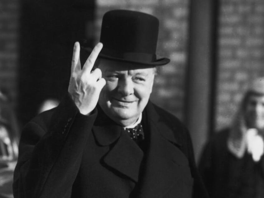 Winston Churchill (1874 - 1965) giving the 'V for Victory' salute in London, after the Bri