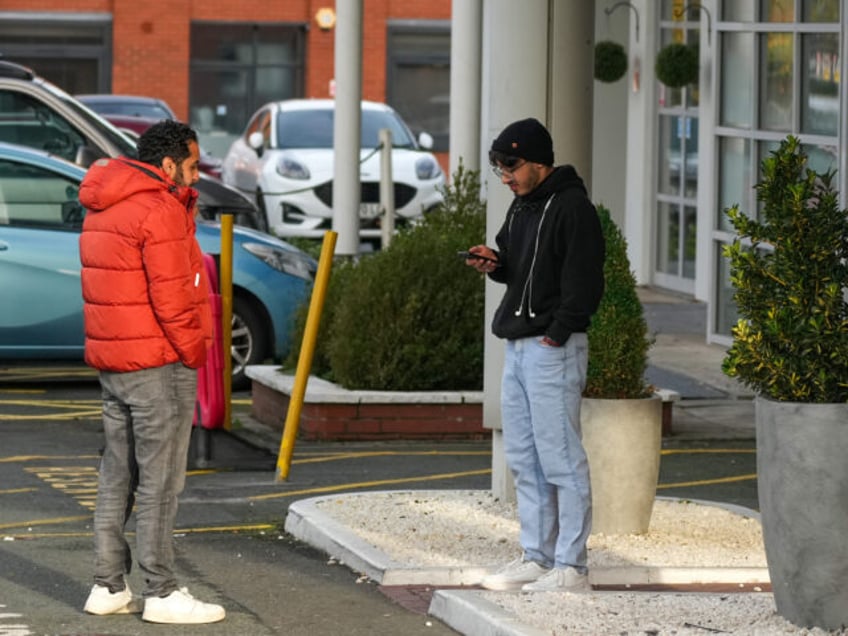 ALTRINCHAM, ENGLAND - NOVEMBER 12: People stand outside the Cresta Court Hotel which is cu