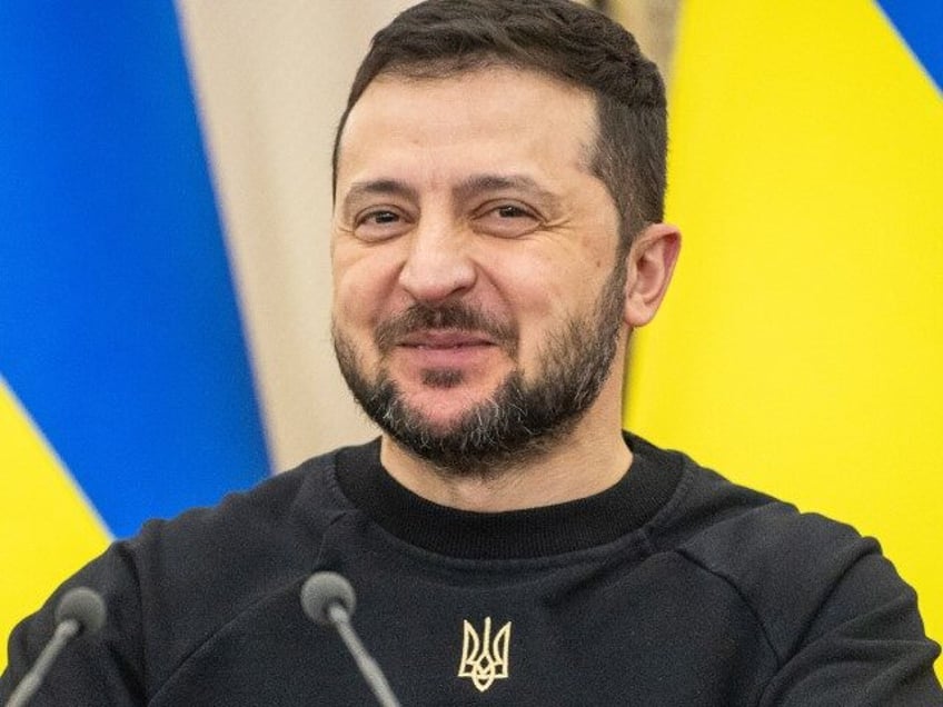 President of Ukraine Volodymyr Zelensky smiles during a press conference following the tri