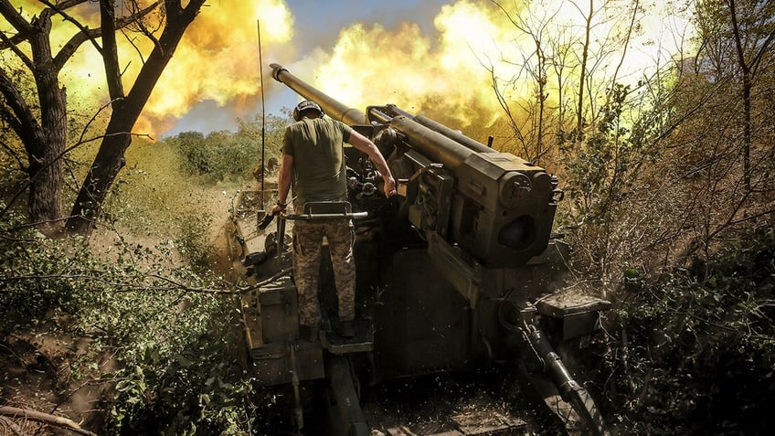 Servicemen of the 24th Mechanised Brigade fire a " Giatsint-S" 152mm self-propelled howitzer toward Russian positions near Chasiv Yar town, in the Donetsk region of Ukraine, on Tuesday, Aug. 20, 2024.