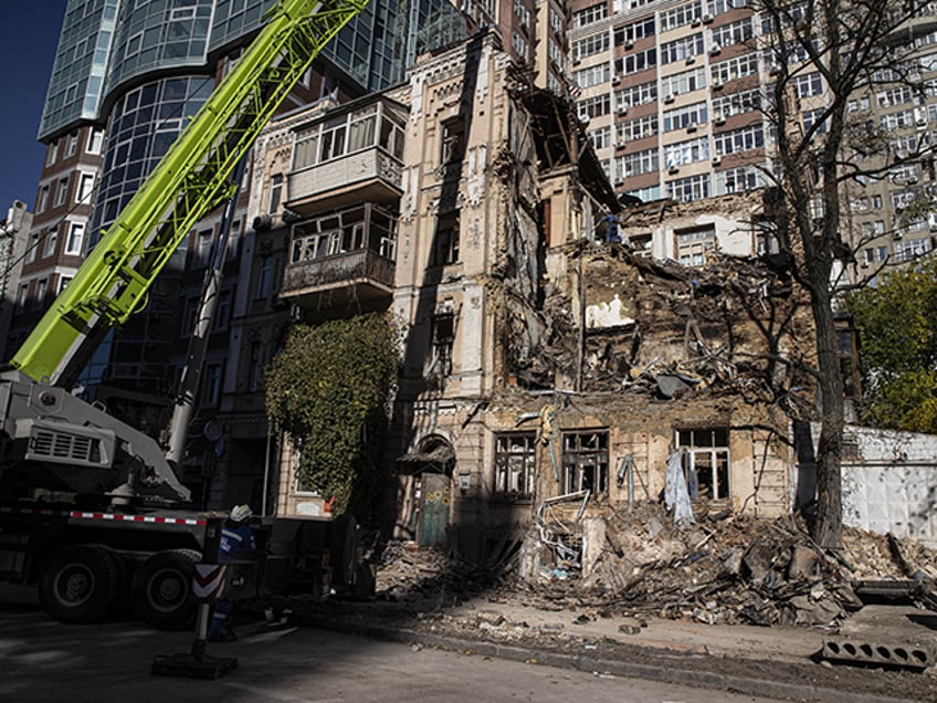 Rescue workers inspect a building destroyed by Russian drone strikes as they continue thei