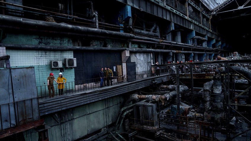 German's Foreign Minister Annalena Baerbock speaks to Ukrainian Energy Minister Herman Halushchenko during official visit to a thermal power plant which was destroyed by a Russian rocket attack