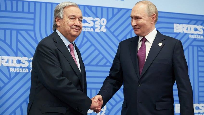 Russian President Vladimir Putin shakes hands with U.N. Secretary General Antonio Guterres