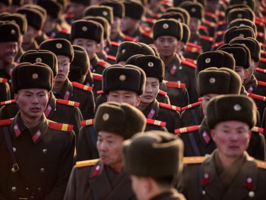 TOPSHOT - Korean People's Army (KPA) soldiers gather as they prepare to pay their respects