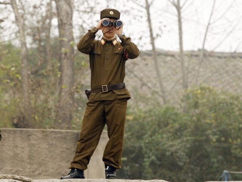 SINUIJI, DEMOCRATIC PEOPLE'S REPUBLIC OF: A North Korean soldier looks through binoculars